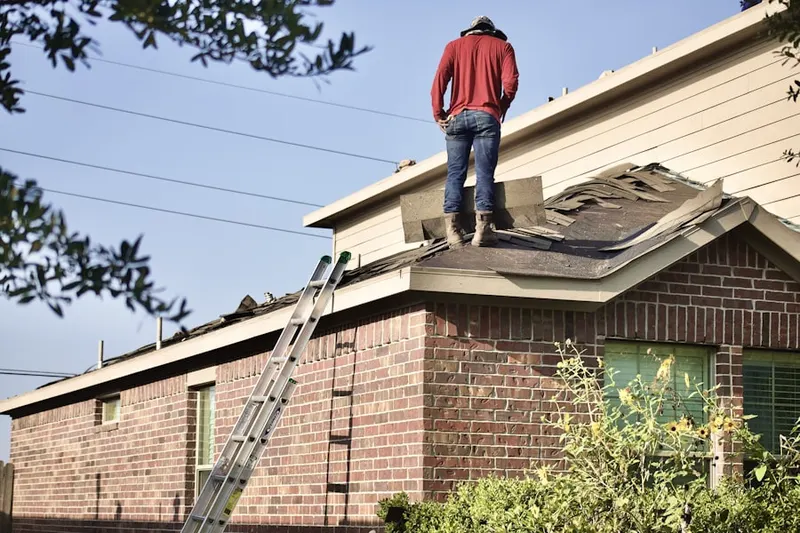 Professional roofer working on a residential roof in Downtown Charleston
